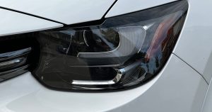 Closeup of a headlight on a white car
