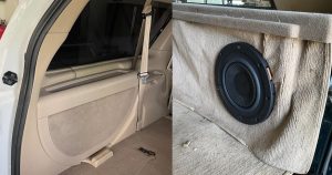 The inside of the back of a car on one side of the image, a speaker installed into upholstery on the other