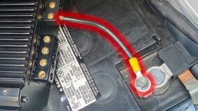 A car audio amplifier attached to a battery