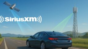 A satellite and radio tower sending waves to a vehicle on a road