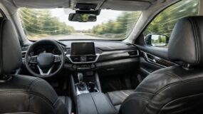 The inside of a vehicle with a view as if you are sitting in the rear left seat