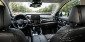 The inside of a vehicle with a view as if you are sitting in the rear left seat