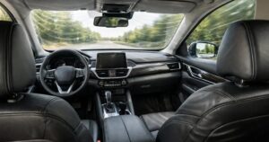 The inside of a vehicle with a view as if you are sitting in the rear left seat